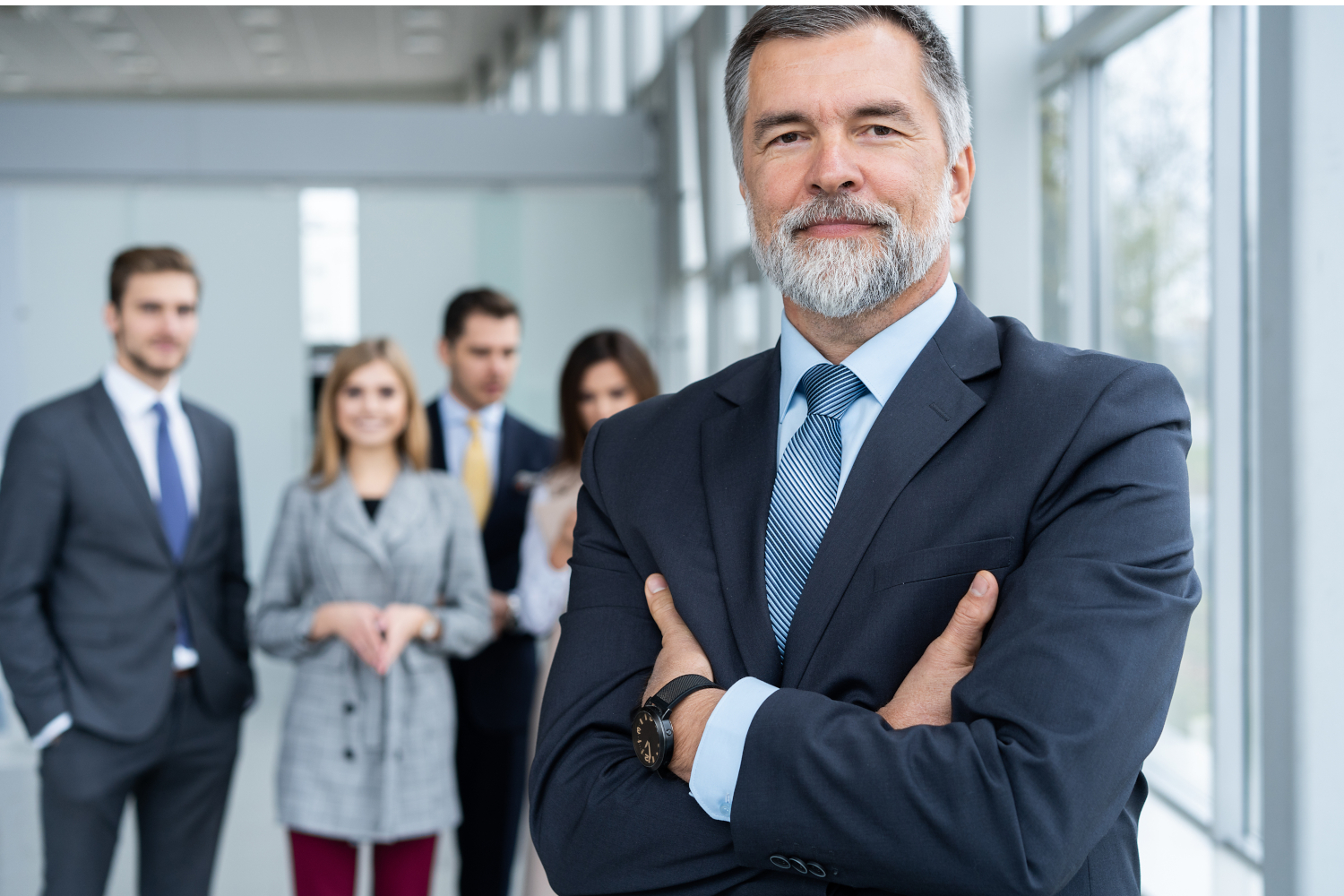 Businessteam in office, Happy Senior Businessman in His Office is standing in front of their team